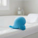 The Heavenly Humpback Waterproof Finger Bullet Vibrator features a sleek, rounded blue design with gentle curves and smooth lines, discreetly shaped like a small whale with flippers, shown from the side on a white background.