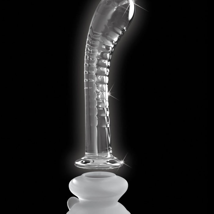 The Icicles Smooth Curved 7 Inch Glass G-Spot and P-Spot Dildo with Suction Cup stands upright against a black background, its clear borosilicate glass surface reflecting light and highlighting its curved design.