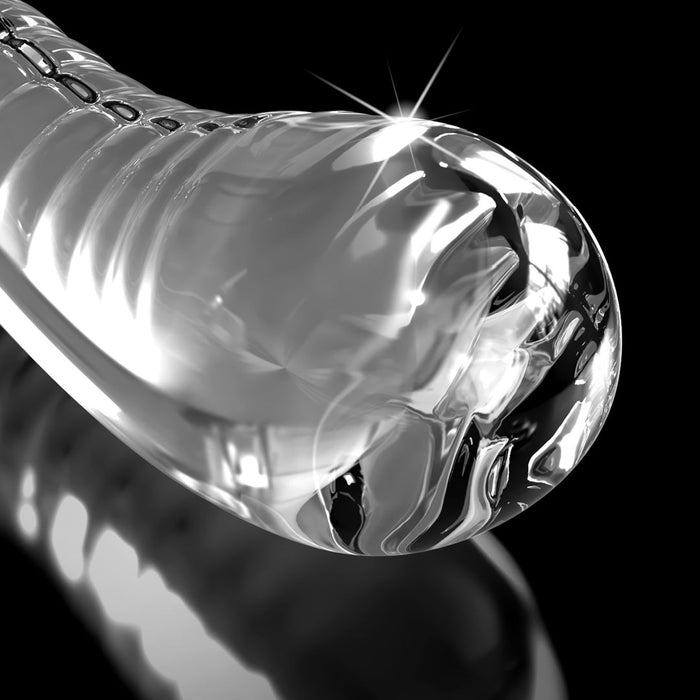 A close-up of the Icicles Smooth Curved 7 Inch Glass G-Spot and P-Spot Dildo with Suction Cup, crafted from smooth borosilicate glass, with light reflections on its curves against a black background.