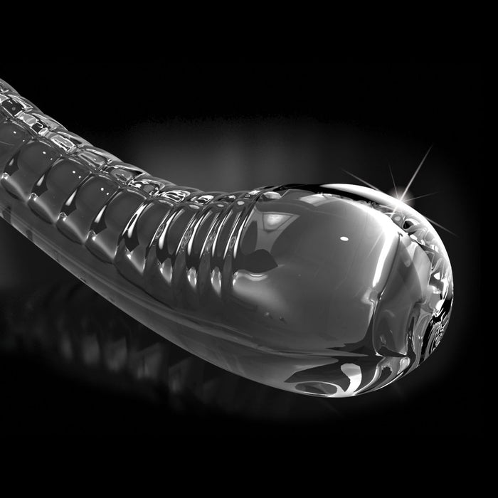 Close-up of the Icicles Smooth Curved 7 Inch Glass G-Spot and P-Spot Dildo with Suction Cup, featuring a glossy, transparent borosilicate glass body and rounded end, shown against a black background with light reflecting on its surface.
