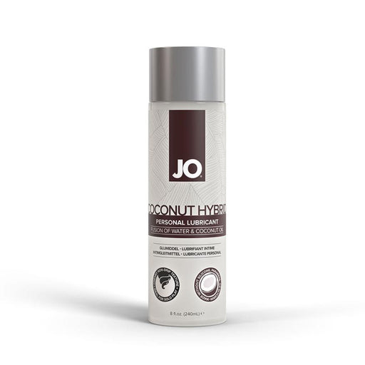 A bottle of System Jo's JO Coconut Hybrid Original Lubricant, boasting a paraben-free, water-based formula and featuring a silver cap, is displayed. The label, adorned with white and brown accents, prominently showcases the product name "Coconut Hybrid" and details its unique blend of water and coconut oil. The bottle has an 8 fl. oz. (240 ml) capacity.
