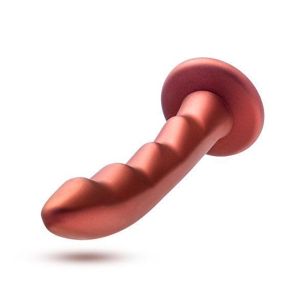 The Jealousy 7 Inch Rippled Red Silicone Dildo, featuring a metallic red color, ribbed curves, and a flared base for pegging, is shown against a white background.