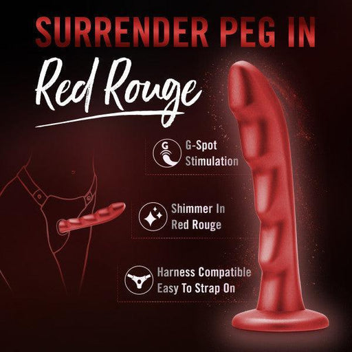 The Jealousy 7 Inch Rippled Red Silicone Dildo stands upright against a dark background, with text highlighting G-spot stimulation, red rouge shimmer, strap-on compatibility, and the phrase “Surrender Peg in Red Rouge.”.