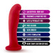 The Jezebel Sleek Curved 6 Inch Red Silicone G-Spot Dildo stands upright beside icons and text showing it’s harness compatible, body safe, fragrance/paraffin/latex/phthalate free, pure silicone, G-spot stimulating, with a heart-shaped suction cup base.