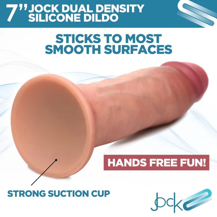 The Jock Dual Density Light Tone Silicone Thick 7 Inch Dildo with Suction Cup is shown on a white background. Blue and red text highlights: "sticks to most smooth surfaces" and "hands free fun!.