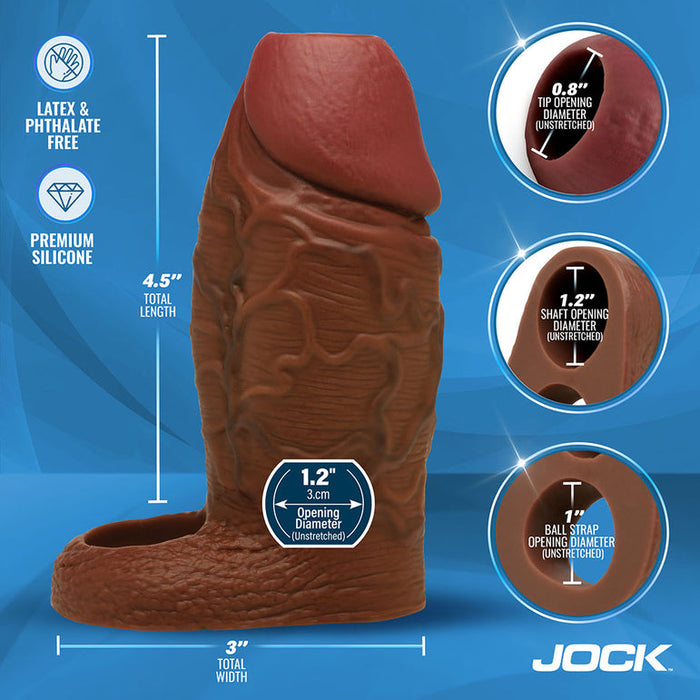 The Jock Girthy Open Ended Silicone Penis Sleeve - Chocolate is a realistic brown sleeve with an open-ended tip, detailed measurements, and a stretchy ball strap for comfort. Displayed on a blue background with the "JOCK" brand name at the bottom.