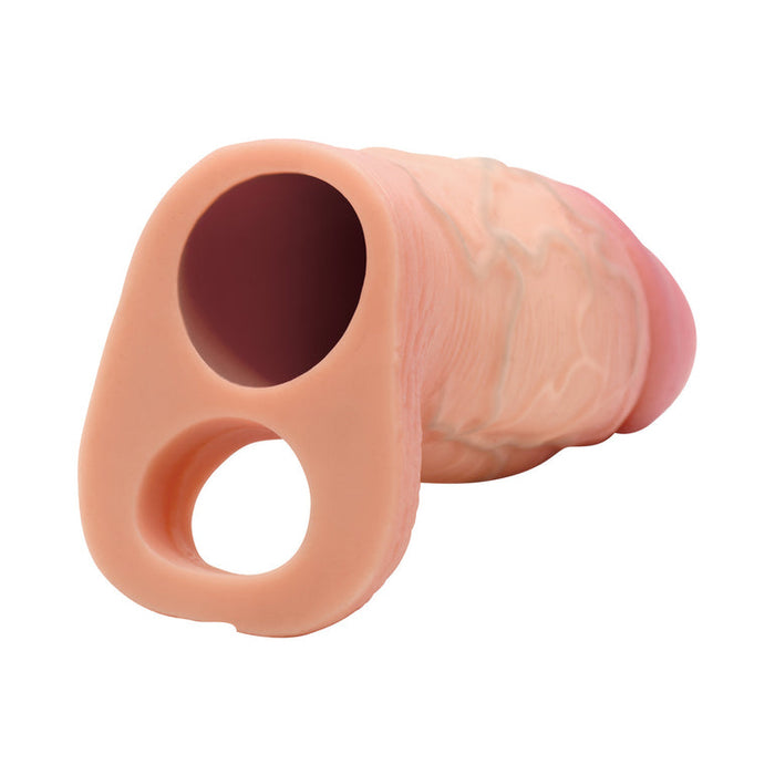 The Jock Girthy Open Ended Silicone Penis Sleeve - Vanilla is a realistic, flesh-toned sleeve with lifelike veins and two circular openings—one serving as a ball strap—designed to resemble a penis, shown on a white background.