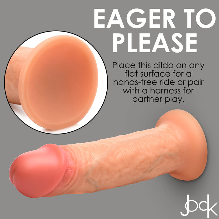 The Jock Real Skin Thick 8 Inch Light Tone Silicone Suction Cup Dildo offers realistic feel and a sturdy base—place it on any flat surface for hands-free fun or use with a harness for partner play. bck logo in corner.
