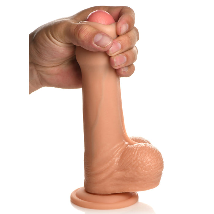 A hand holds the Jock Real Skin Thick 8 Inch Light Tone Silicone Suction Cup Dildo with Balls, showcasing its lifelike texture and realistic details, against a white background.