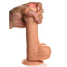 A hand holds the Jock Real Skin Thick 8 Inch Light Tone Silicone Suction Cup Dildo with Balls, showcasing its lifelike texture and realistic details, against a white background.