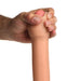 A hand squeezes the Jock Real Skin Thick 8.5 Inch Light Tone Silicone Suction Cup Dildo, showing its realistic detail and flexible design against a white background.