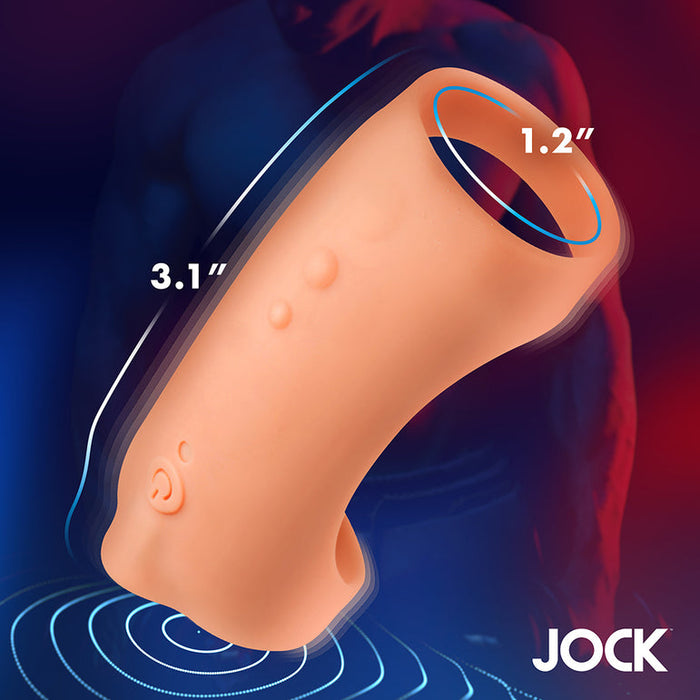 The Jock Vibrating Penis Sleeve and Support with Remote - Caramel features a flesh-toned 1.2-inch diameter opening, 3.1-inch length, on a blue and red background with a subtle muscular figure and "JOCK" at the bottom right.