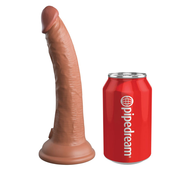 The King Cock Elite Realistic 7 Inch Dual Density Medium Tone Silicone Dildo with a sturdy suction cup base stands upright next to a red soda can labeled "pipedream" for size comparison.