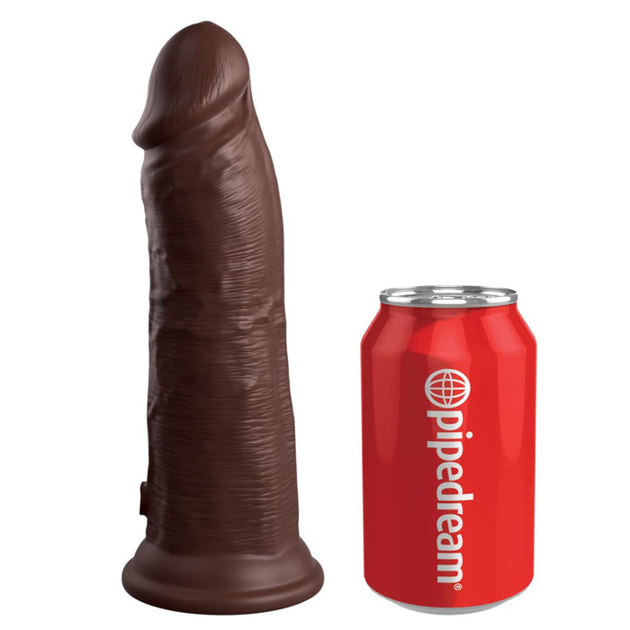 The King Cock Elite Thick 8 Inch Dual Density Dark Tone Silicone Dildo stands upright beside a red soda can with “pipedream” and a globe logo, showcasing the suction cup dildo's impressive size.