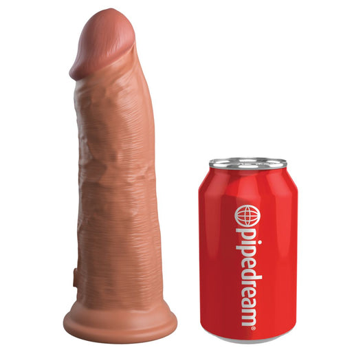 The King Cock Elite Thick 8 Inch Vibrating Dual Density Medium Tone Silicone Dildo stands upright beside a red "pipedream" soda can, clearly showing their size comparison.