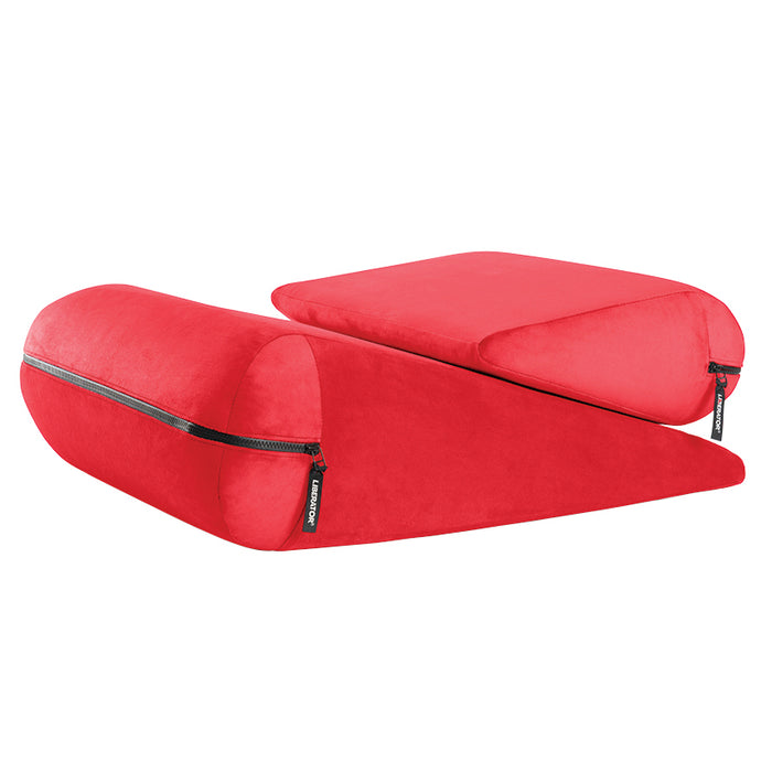 Two bright red foam wedges—the Liberator Jaz Duet Dual-Cushion Positioning Support—one rectangular and one triangular, both with soft covers and visible zippers, are placed side by side on a white background.