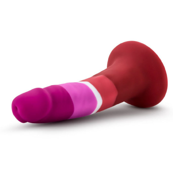 The Lesbian Pride Small 5.5 Inch Silicone Suction Cup Dildo features a silky, colorful red, pink, magenta, and white gradient—evoking the Lesbian flag—with a flared suction cup base, shown on a white background.
