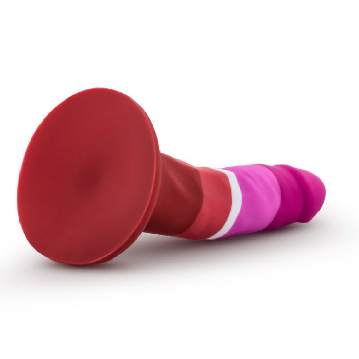 The Lesbian Pride Small 5.5 Inch Silicone Suction Cup Dildo features silky silicone in bold red, pink, and purple hues inspired by the Lesbian flag, shown lying on its side with its wide base against a white background.