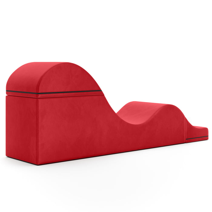 The Liberator Aria Flip Chaise Sex Lounger, a modern red ergonomic bench with a unique wavy shape, raised backrest, central dip, and slightly elevated footrest, is shown against a white background.