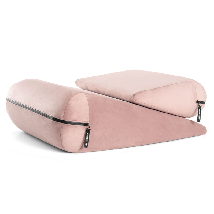 Two soft, pink Liberator Jaz Duet Dual-Cushion Positioning Supports with black zippered covers are stacked side by side on a white background. Each wedge has a unique slope, offering ergonomic support as versatile sex furniture.