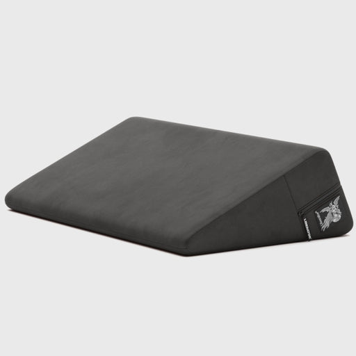 The Liberator Wedge Sex Positioning Cushion - 30 Inches is a black, wedge-shaped pillow made with high-density foam and a soft cover, featuring a small logo tag, shown against a plain light gray background.