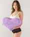 Liberator Faux Fur Heart Wedge Sex Positioning Cushion - Purple held in model's hand with dark hair and white and black lingerie 