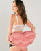 Dark Haired Female Model wearing lingerie holding Liberator Faux Fur Heart Wedge Sex Positioning Cushion - Pink behind her back 