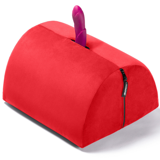 The Liberator BonBon Rideable Sex Toy Mount is a red, semi-cylindrical cushion with a zippered side and an opening on top for mounting a sex toy vertically.