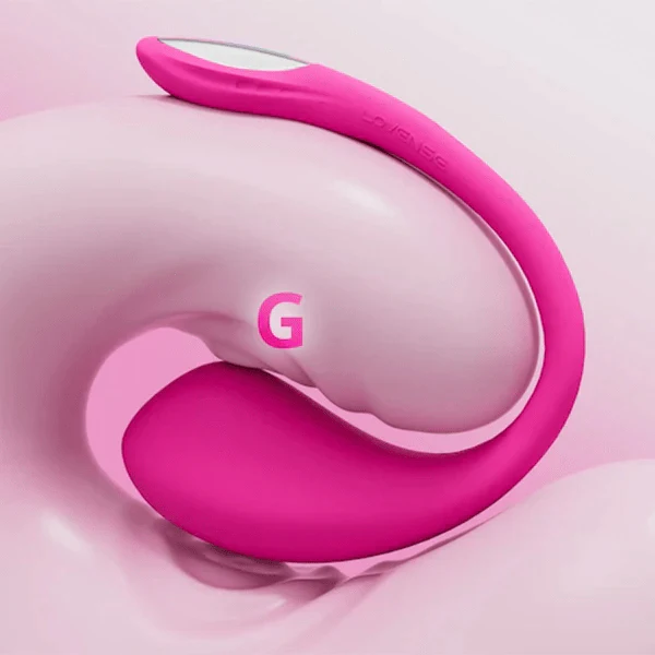 The Lovense Lush 4 Sound Activated Bluetooth Wearable Vibrator, in pink silicone with a curved design for G-spot stimulation, is shown on a soft pink abstract background with a bold "G" marking its pleasure zone.