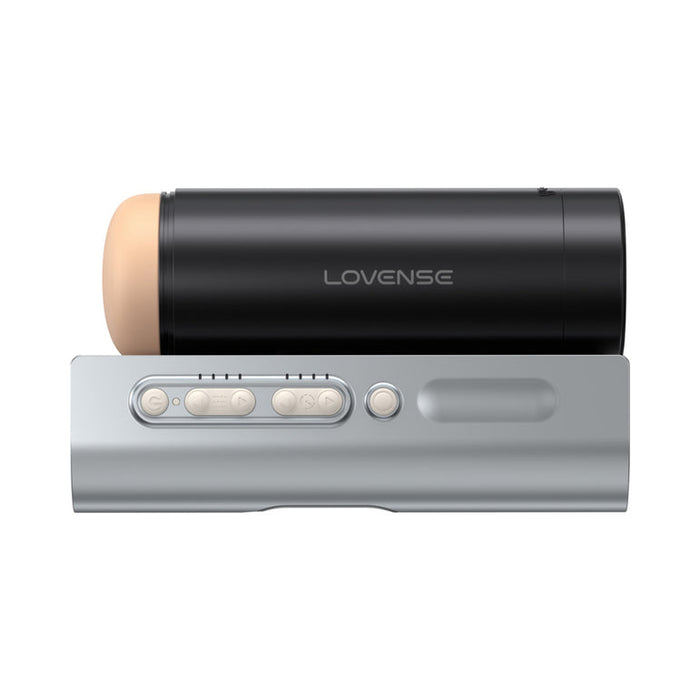 The Lovense Solace Pro AI Powered Thrusting Masturbator with Remote Control—a black, cylindrical stroker with a beige tip labeled "Lovense"—rests on a gray base with buttons and a circular control, shown against a white background.