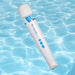 A Magic Wand Waterproof Rechargeable Cordless Vibrator in white and blue with buttons floats above rippling water.