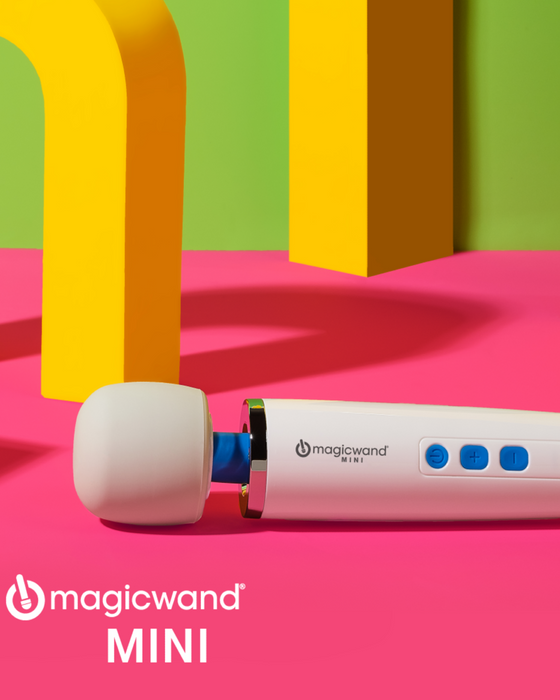 Magic Wand Mini Cordless Rechargeable Vibrator on pink yellow and green background 