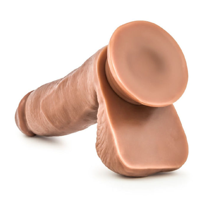 Manny the Fireman Realistic 6.75 Inch Medium Tone Dildo is made from silicone, with an exaggerated flat circular suction cup base for hands-free use, displayed against a white background.