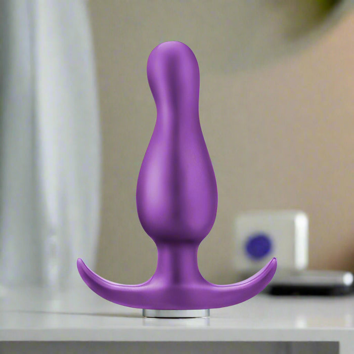 The Matrix First Time Flexible Silicone Butt Plug - Galactic Purple by Blush is a purple, platinum-cured silicone butt plug with a curved base for safety. Its sleek, smooth design features a bulbous middle section that tapers to a rounded tip, making it perfect for P spot stimulation and part of the Anal Adventures Matrix collection.