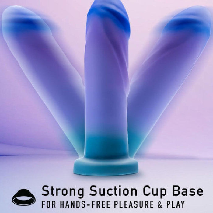 The Midnight Rendezvous Textured 7.5 Inch Girthy Blue Silicone Dildo stands upright with a strong suction cup base for hands-free pleasure & play, crafted from body-safe silicone in striking blue and purple.