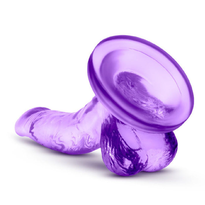 The Naturally Yours Small Realistic 4 Inch Purple Mini Dildo is a translucent silicone toy with a realistic shape, textured details, and a suction cup base—ideal for beginners exploring strap-on play and new sensations.