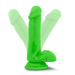 The Neo Elite Beginner 6 Inch Dual Density Dildo is a green silicone dildo with balls and a suction cup base, shown flexibly in three positions to show its lifelike feel—great for realistic strap-on play or solo fun.