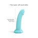 A teal glitter silicone dildo with a smooth, soft-touch finish and suction cup stands upright. Text reads "Nightfall Smooth 7 Inch Dildo," ideal for G-spot or prostate play. Length: 17.8 cm by 3.5 cm (7" x 1.38") insertable length.