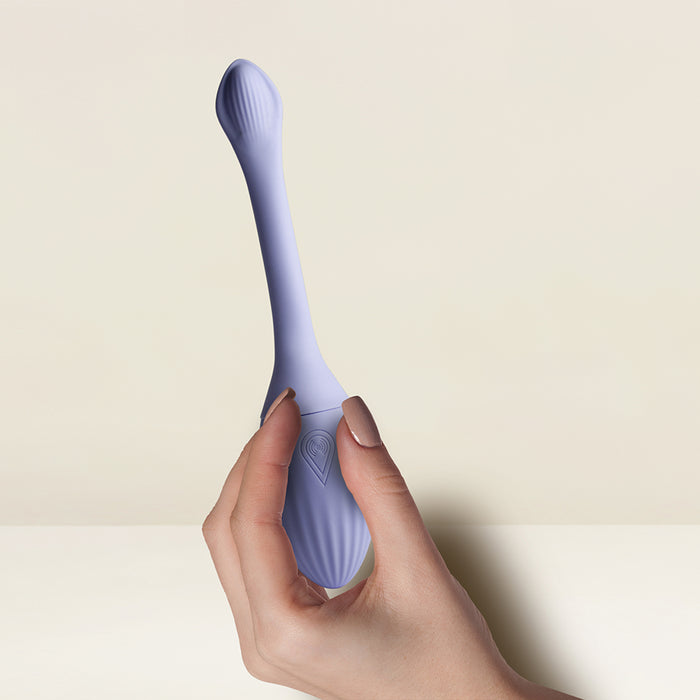A hand holds the Niya Rechargeable Kegel Exerciser and Vibrator with Remote, a sleek lavender silicone device, against a neutral background—ideal for effective pelvic floor strengthening.
