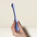 A hand holds the Niya Rechargeable Kegel Exerciser and Vibrator with Remote, a sleek lavender silicone device, against a neutral background—ideal for effective pelvic floor strengthening.