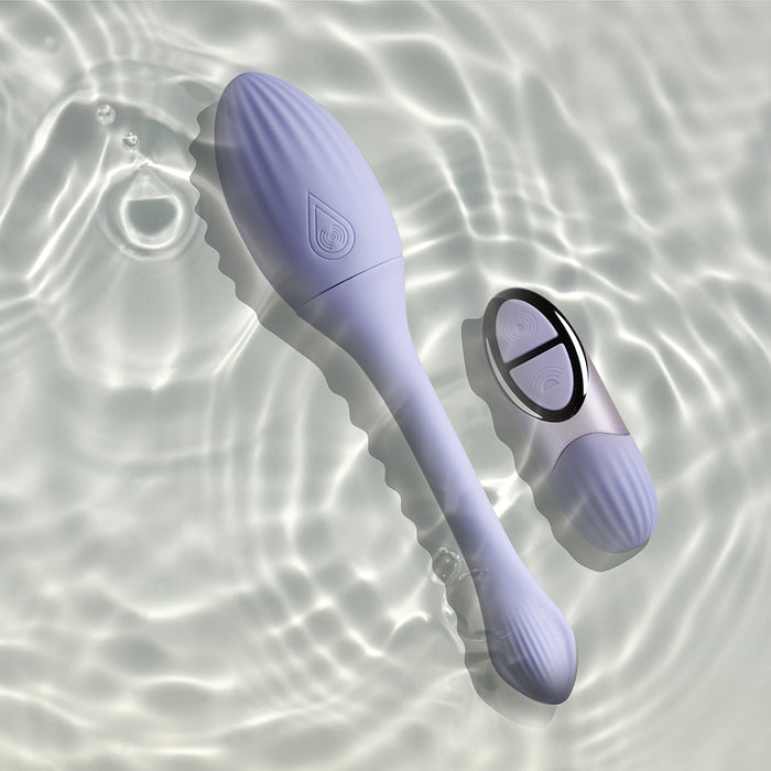 The Niya Rechargeable Kegel Exerciser and Vibrator with Remote—a pale lavender device—rests in clear, sunlit water, designed for discreet use and effective pelvic floor strengthening.