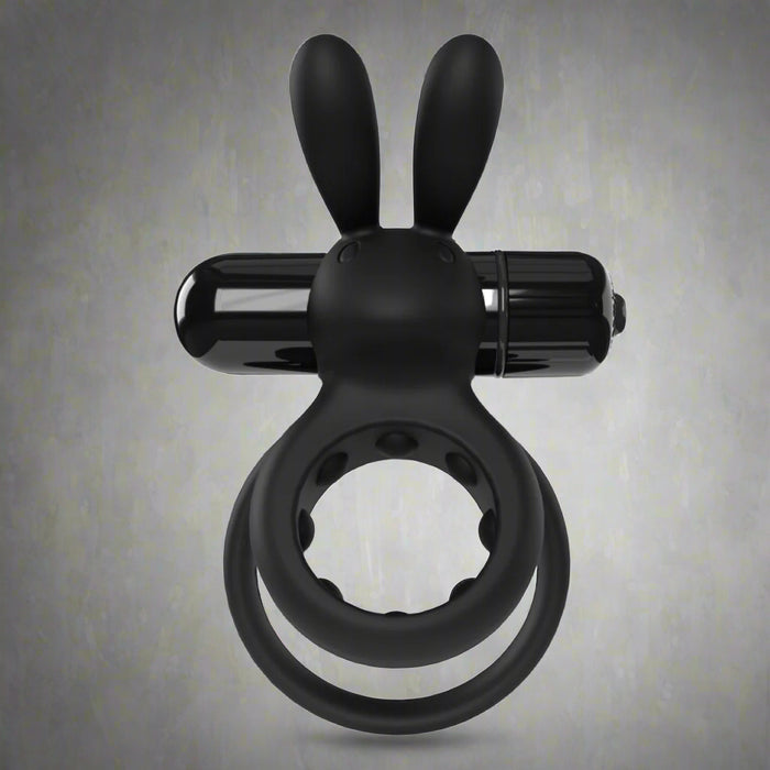 The O Hare Deep Rumbling Vibrating Beginner Couples' Cock Ring, a black silicone adult toy with bunny ears and a cylindrical attachment, is displayed against a plain gray background.