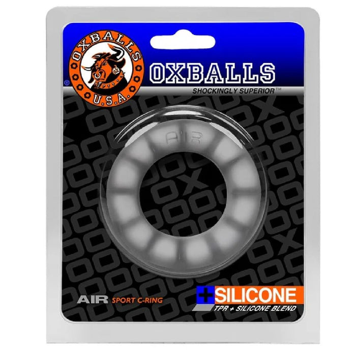 The packaging of the Oxballs Oxballs Air Flow Light Stretchy Cock Ring - Clear features a grey circular silicone ring, made with a super-soft silicone blend and Thermoplastic Rubber (TPR) for flexibility and long-wear comfort. Designed to be shockingly superior, it also serves as a bulge-enhancing cockring.