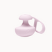 Light pink, compact silicone finger vibrator with a removable tether and intuitive control button.