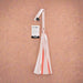 The Peaches 'n Cream Flogger by Sportsheets features a lively combination of pink and white faux leather strands, complemented by a chic tag on the handle.