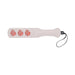The Sportsheets Peaches 'n Cream Impression Paddle is elegantly crafted from smooth faux leather, featuring three peach-shaped cutouts and a black wrist strap, making it ideal for impact play.
