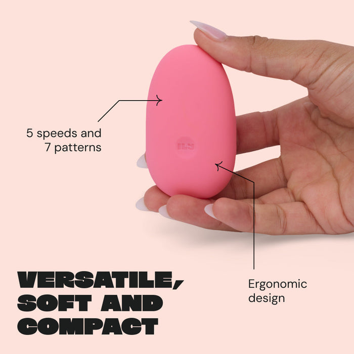 A hand holds the Ily Squishy Silicone Pebble Vibrator, a pink, oval-shaped device with 5 speeds, 7 patterns, and an ergonomic design. Bold text reads: "Versatile, soft and compact." Made from body-safe silicone for gentle clitoral stimulation.