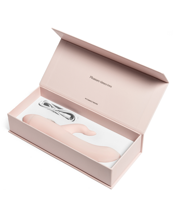 Luxurious pink box containing a Pepper Indulge Magnetic Rabbit Vibrator and charging cable, presented in an elegant and minimalistic style.