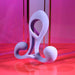 The Playboy Fantasy Cock Cage, a sculptural lavender vibrating silicone toy, stands upright on a glossy pink and red surface against a vivid pink and purple background.