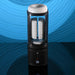 The Playboy Side Piece Heated Sliding Stroker, a black and transparent cylindrical masturbator with a soft white interior and digital display, sits on a reflective surface against a blue wavy background.